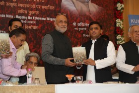 Rahul Mehrotra, left, and Shri Akhilesh Yadav, Honorable Chief Minister. hold the book