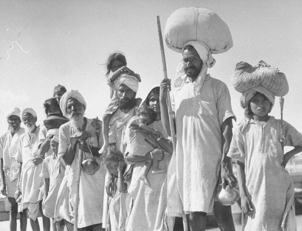 Circa 1947: Convoy of Sikhs carrying their belongings on their heads as they migrate to East Punjab after the division of India. (Photo by Margaret Bourke-White/The LIFE Picture Collection/Getty Images)
