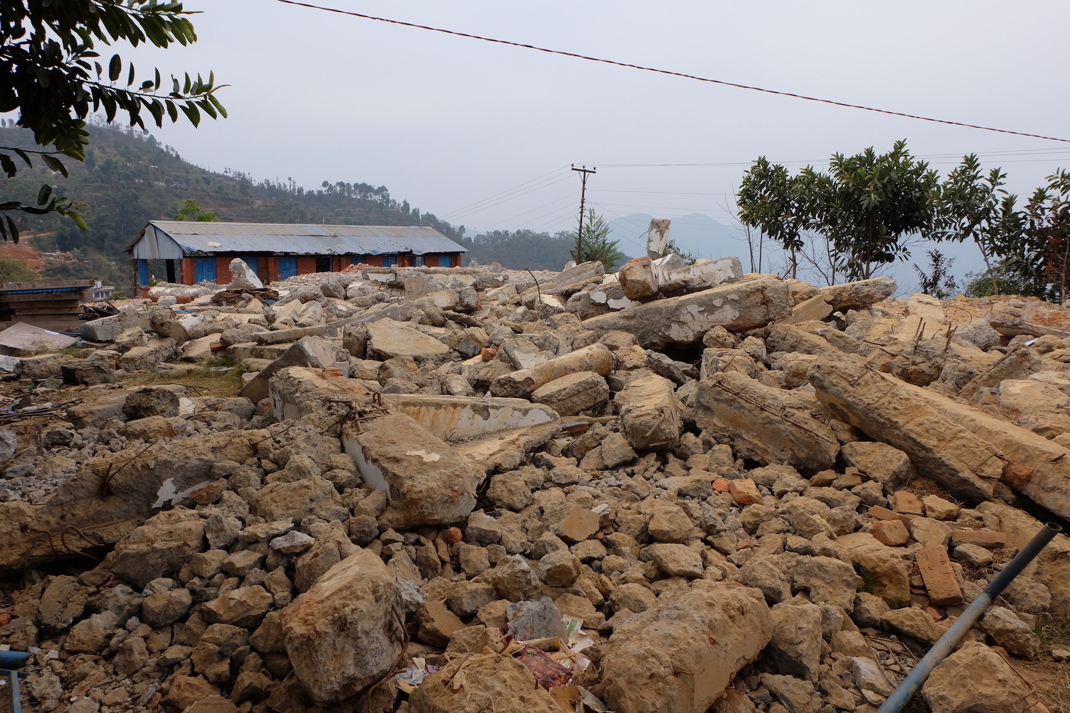 A two-story school used to stand at this site in Sindupalchowk District. Most of the walls collapsed and the frame was damaged in the earthquake. What was left of the structure was demolished to prepare for a new school.