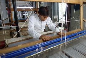 A handloom school student at the loom