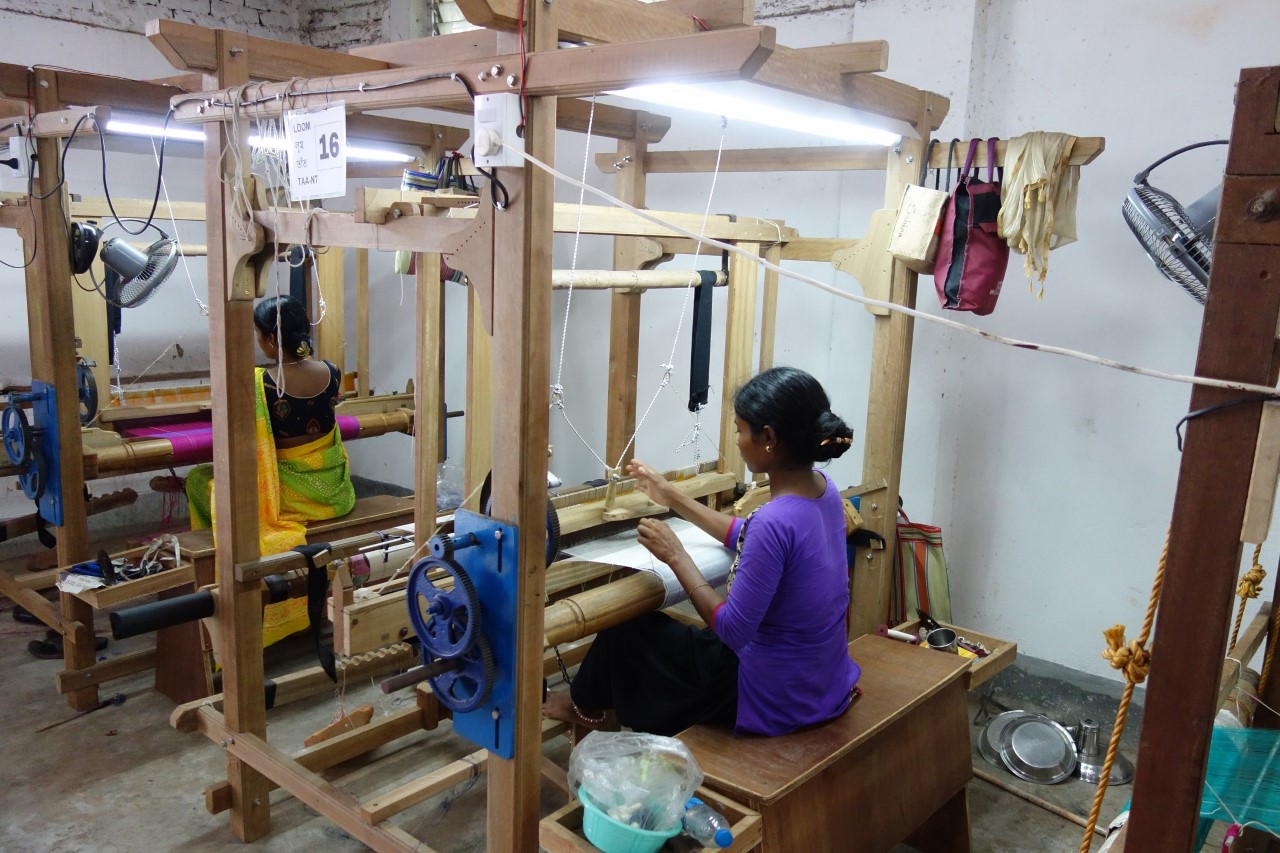Artisans working on ergonomically designed looms