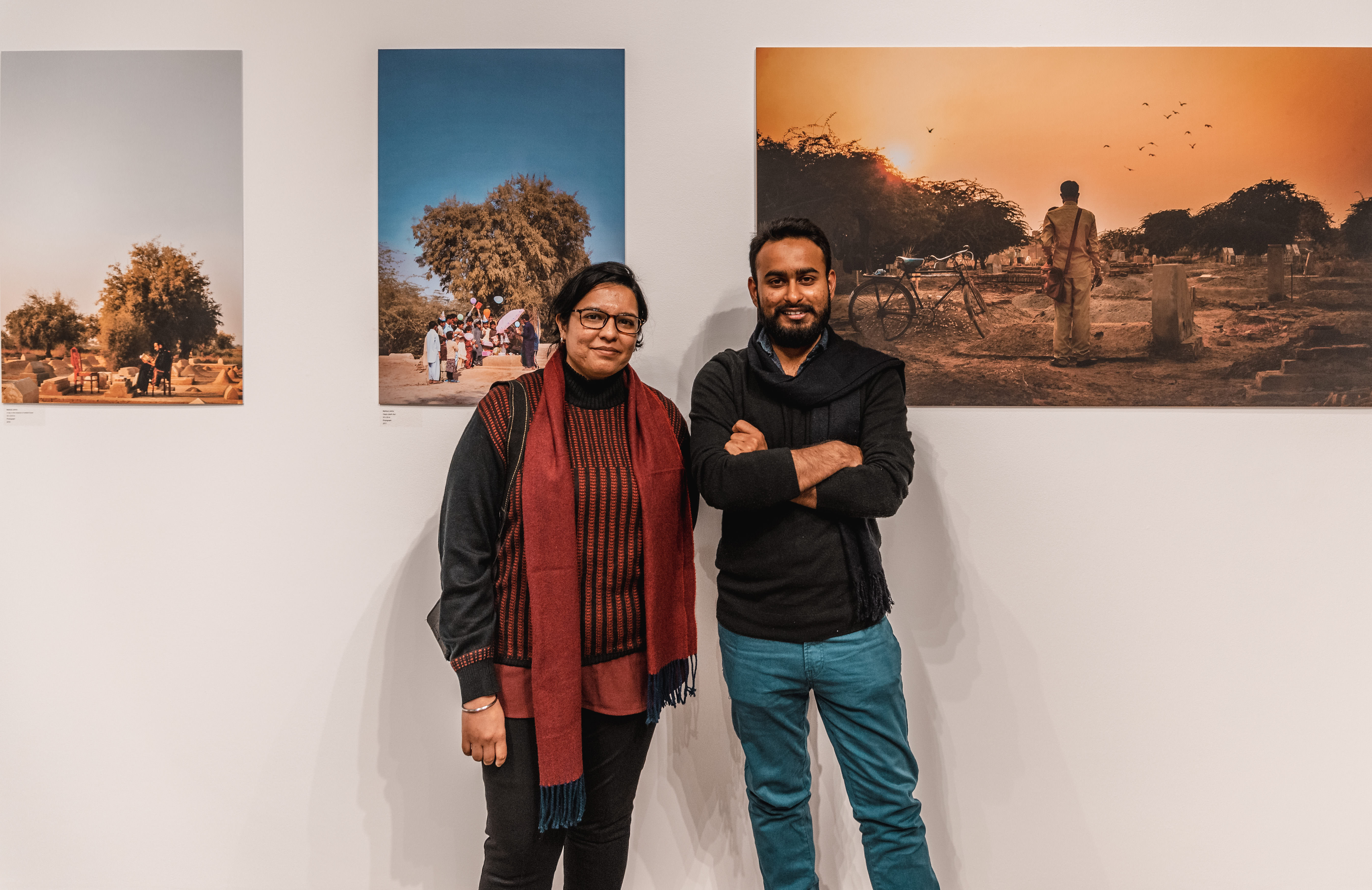 Krupa Makhija (left) and Mahboob Jokhio (right), the Mittal Institute’s Spring 2019 Visiting Artist Fellows, pose in front of Jokhio’s art at an exhibition of their work.
